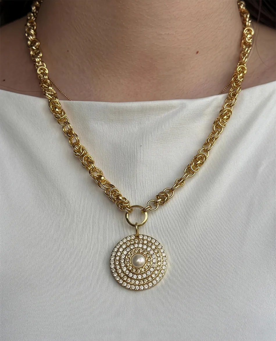 Gold chain necklace with circular pendant featuring pearls and crystals. Link to 