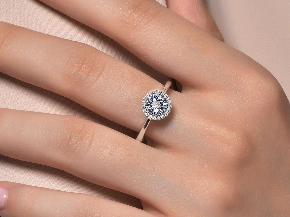 Elegant diamond engagement ring on a hand, showcasing a beautiful design.