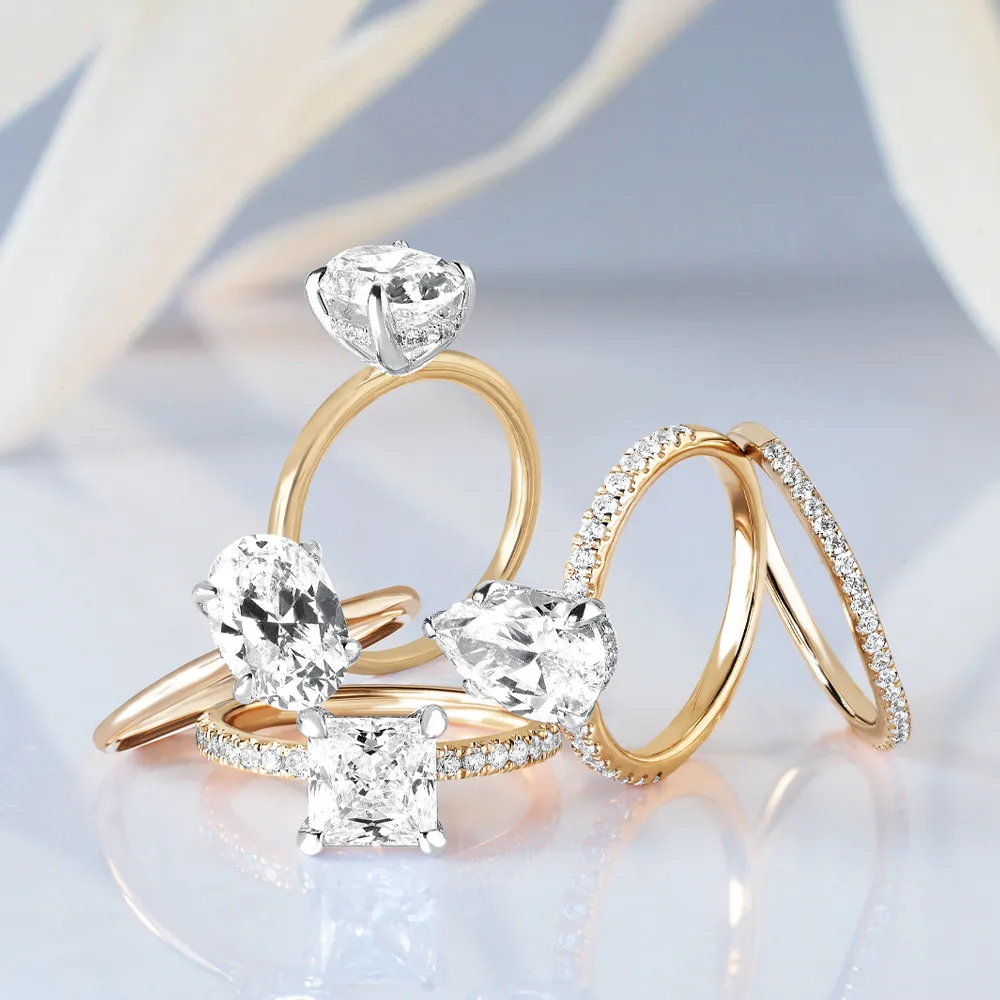 Elegant collection of diamond engagement rings in gold and silver settings, showcasing various styles and designs.