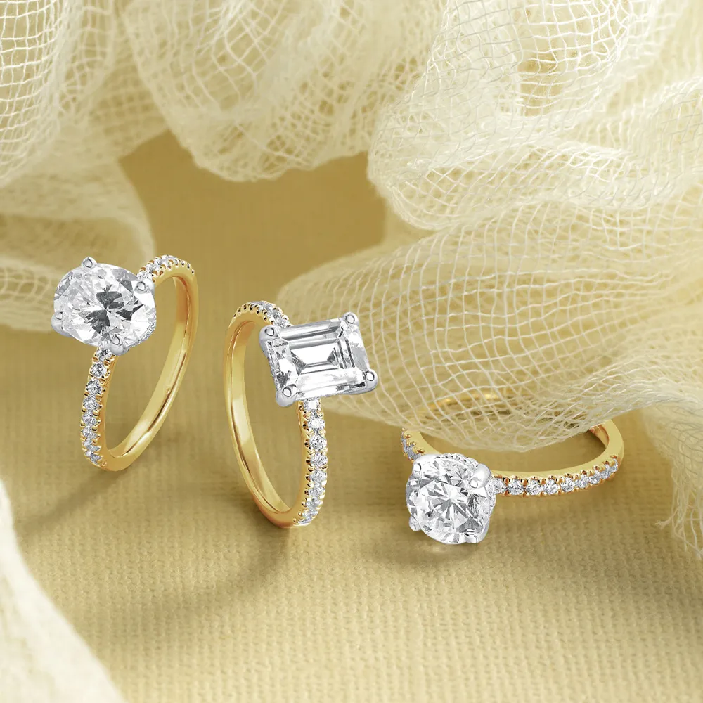 A hand holding tulips with a diamond engagement ring, showcasing elegance and beauty.