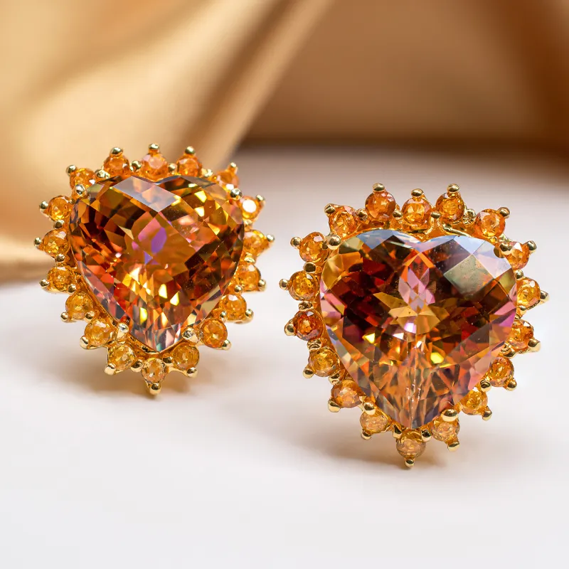 Heart-shaped orange crystal earrings with gold accents, perfect for adding elegance to any outfit.