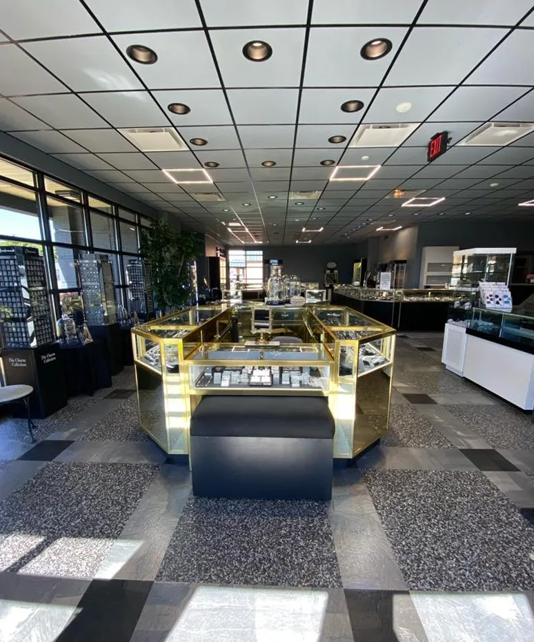 Interior view of Genesis Jewelry store in Muscle Shoals, showcasing display cases and a modern layout.
