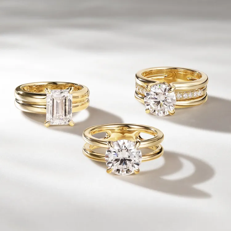 Three elegant gold engagement rings featuring various diamond cuts, displayed on a soft background.