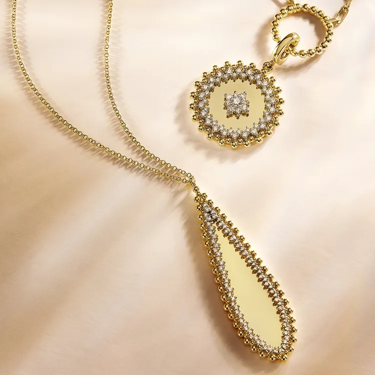 Elegant gold necklace with a teardrop pendant and circular diamond accents. Shop at Jim Kryshak Jewelers in Wausau.