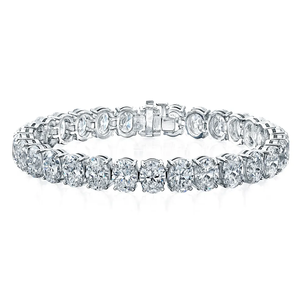 Luxury custom gold bangles and diamond tennis bracelets featuring secure, hand-finished clasps by Joel's Fine Jewelry.