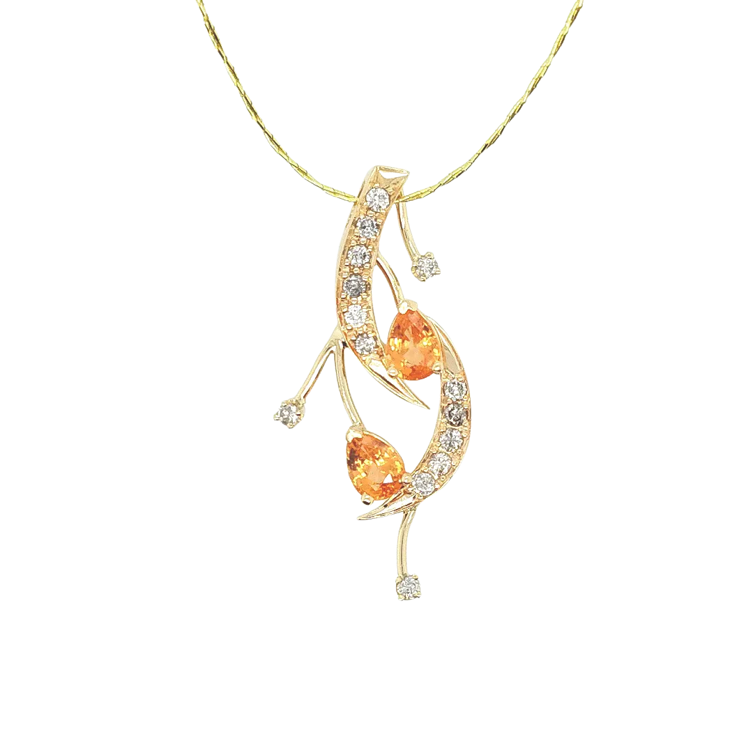 Woman wearing a custom yellow gold pendant with two pear-shaped citrines and diamonds on a flowing vine design