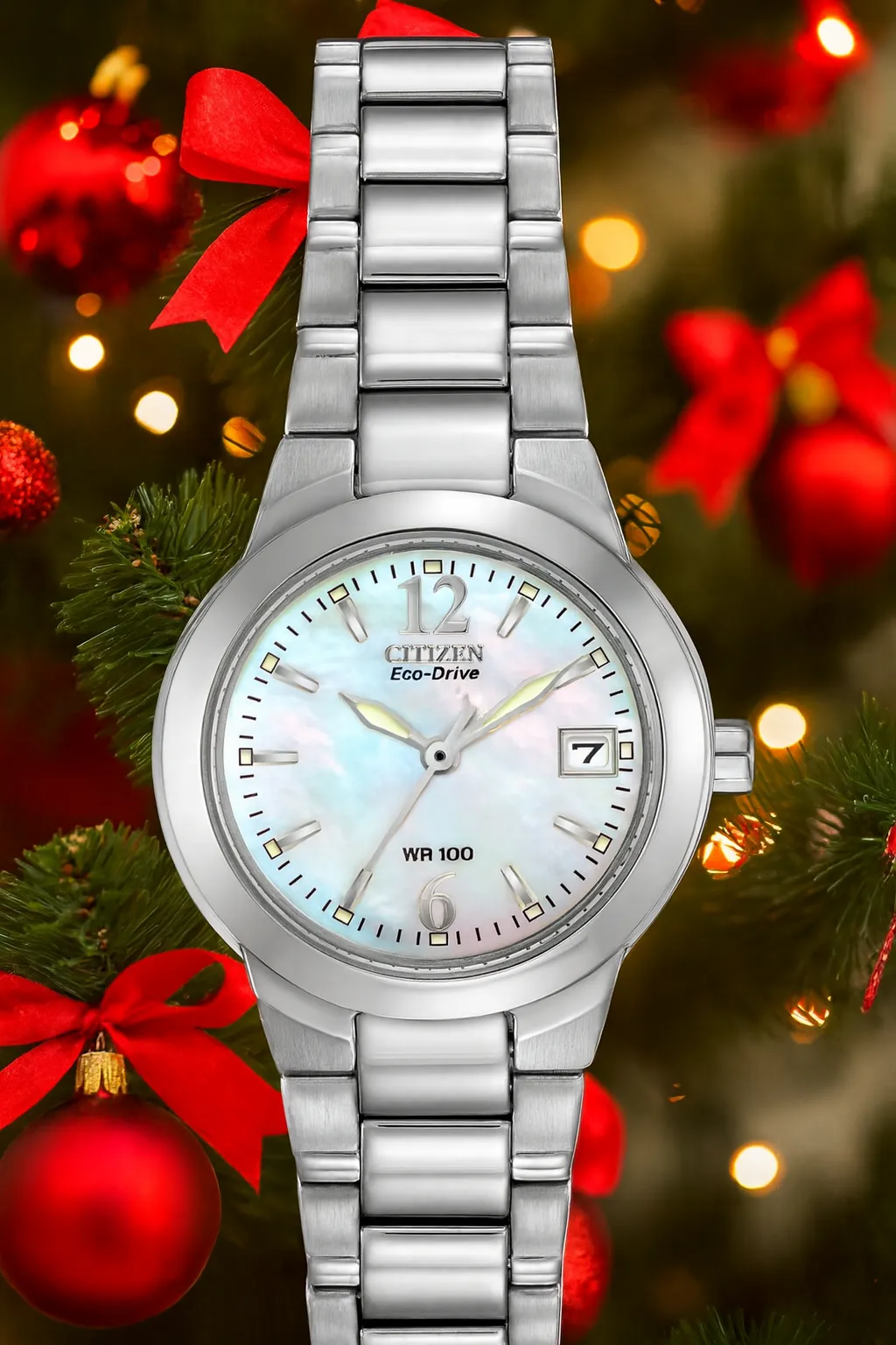 Citizen Eco-Drive watch with a mother-of-pearl face, set against a festive Christmas background. Shop at J. West Jewelers.