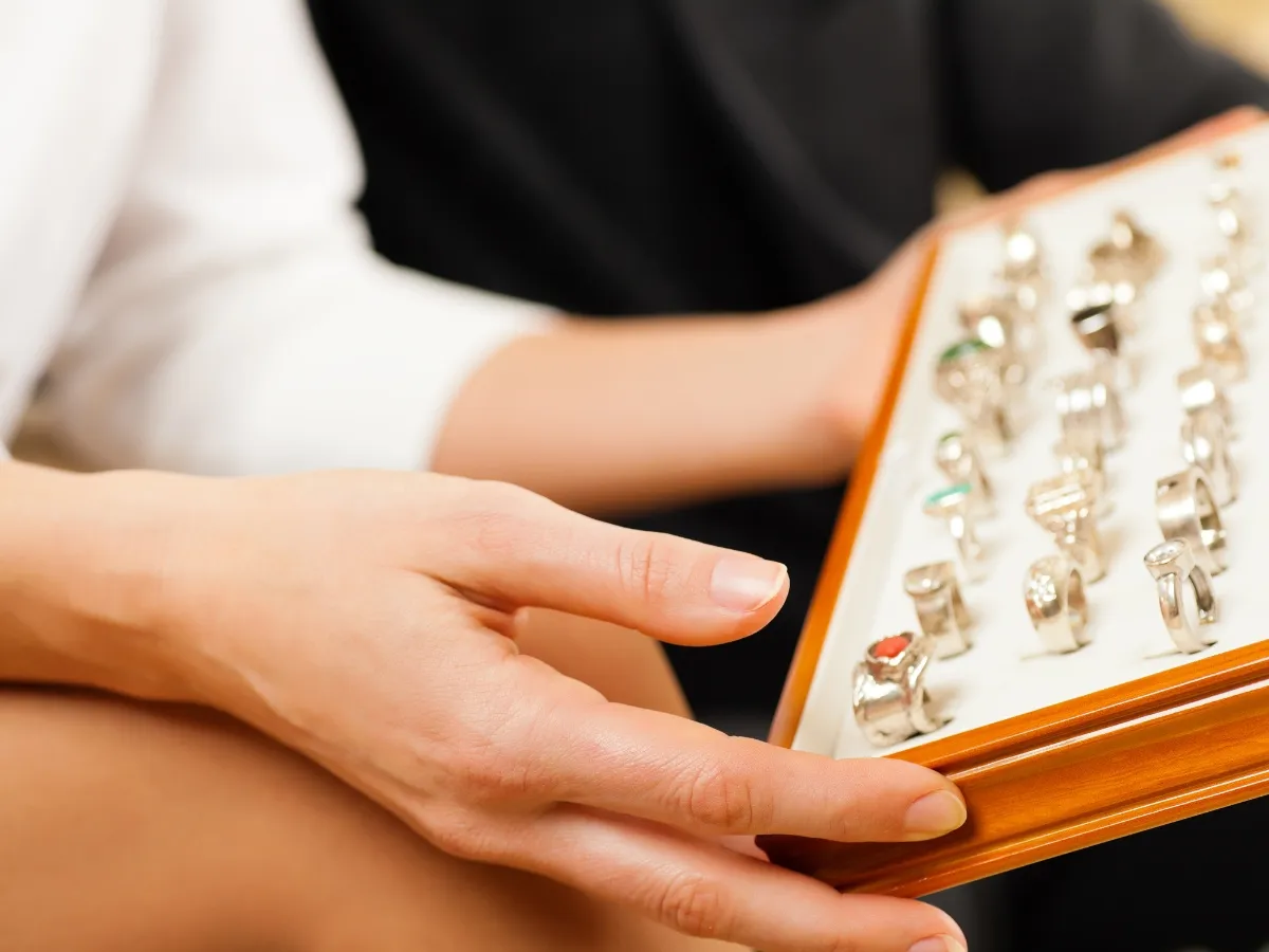 Hand holding jewelry box with rings