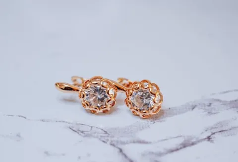 Gold floral diamond earrings with round stones