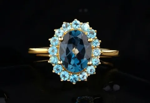 Oval blue topaz halo ring