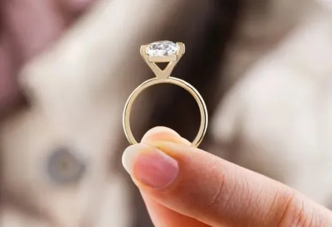 Close-up of custom engagement ring with gold band.