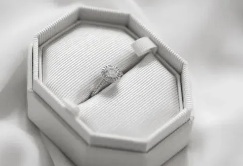 Custom engagement ring in elegant white octagon box.