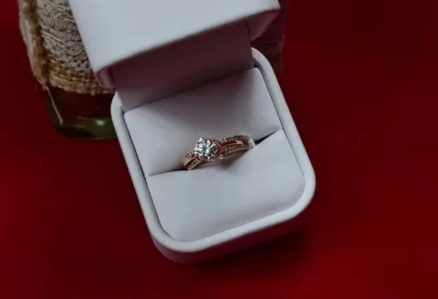 Custom engagement ring in white box.