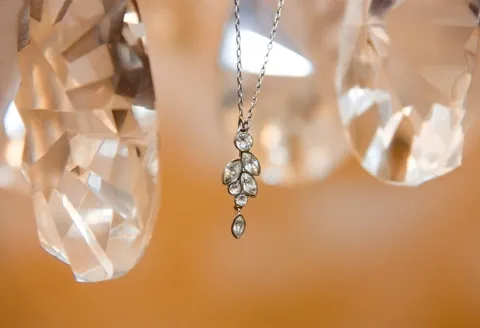 Silver necklace with leaf-shaped diamond pendant