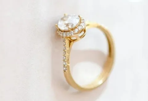 Gold diamond engagement ring with halo setting.