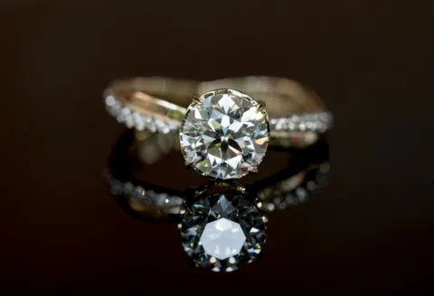 Gold engagement ring with round diamond