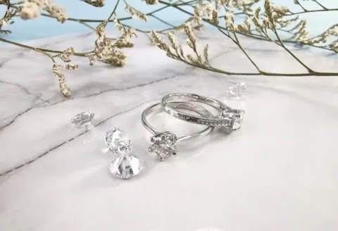 Diamond engagement rings on marble background