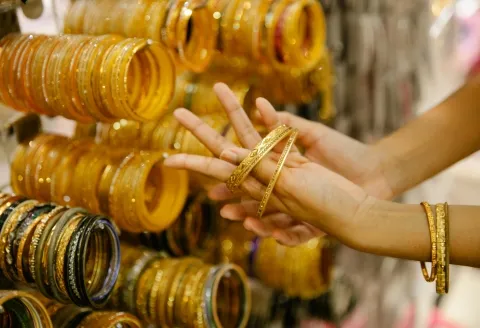 Bangle stack this season styled with gold