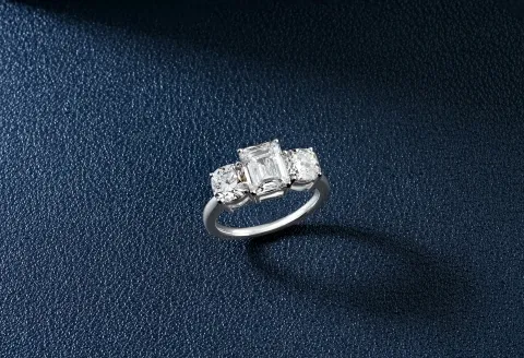 Silver engagement ring with three diamonds in a row