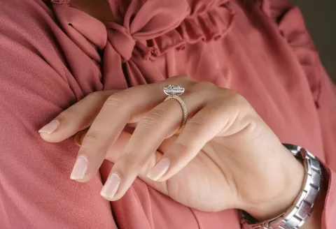 Close-up of a woman’s hand wearing a diamond ring