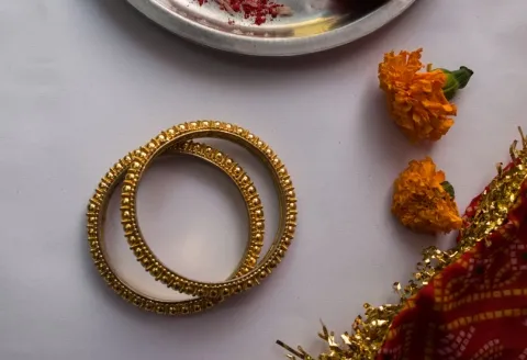 Two gold bangle bracelets showing details