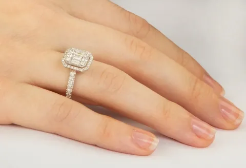 Close-up of emerald cut diamond engagement ring.