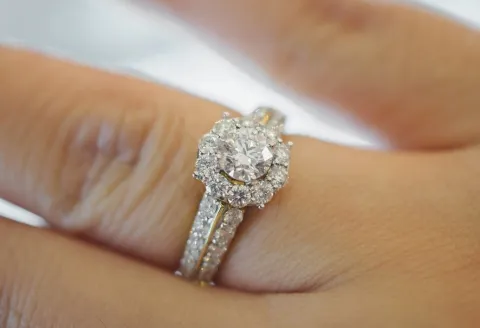 Close-up of halo diamond engagement ring.
