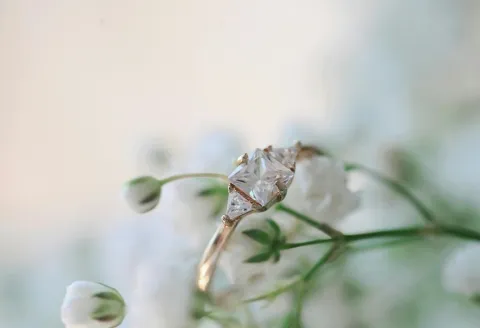 Diamond ring surrounded by delicate white flowers.