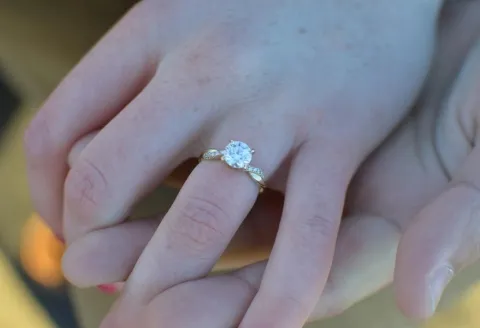 Gold engagement ring with round diamond