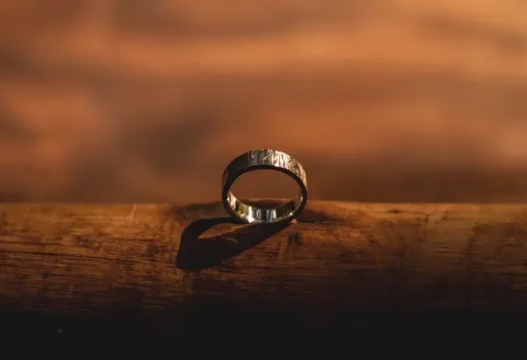 Silver men's wedding band in warm light