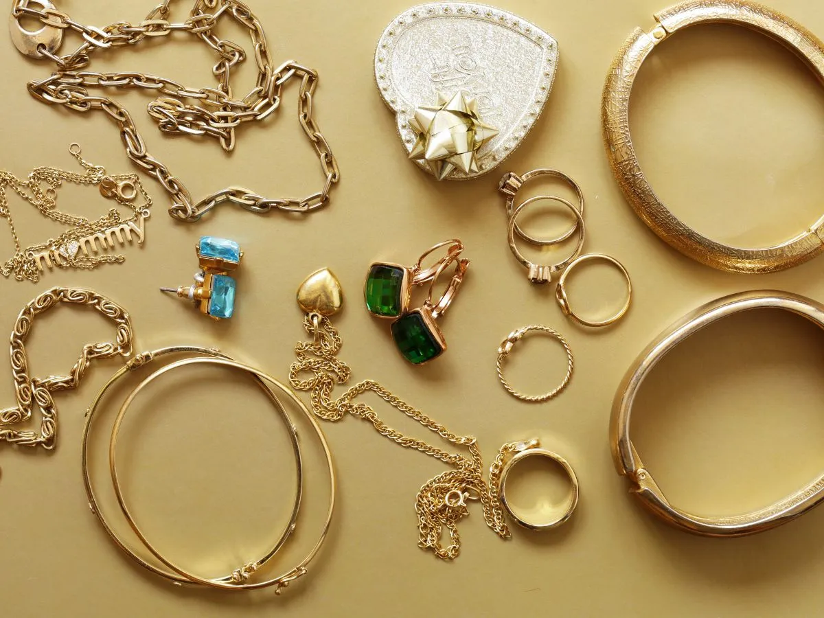 Various gold jewelry with gemstones and chains