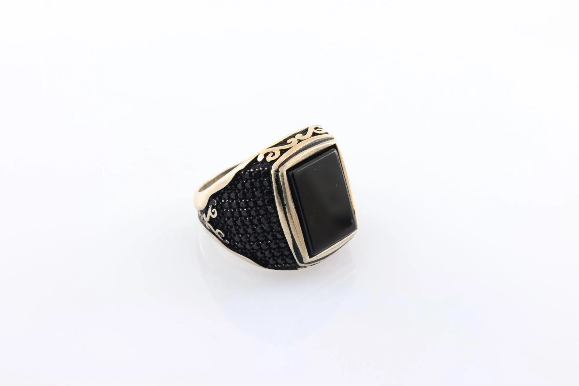 Statement rings with intricate design and black stone