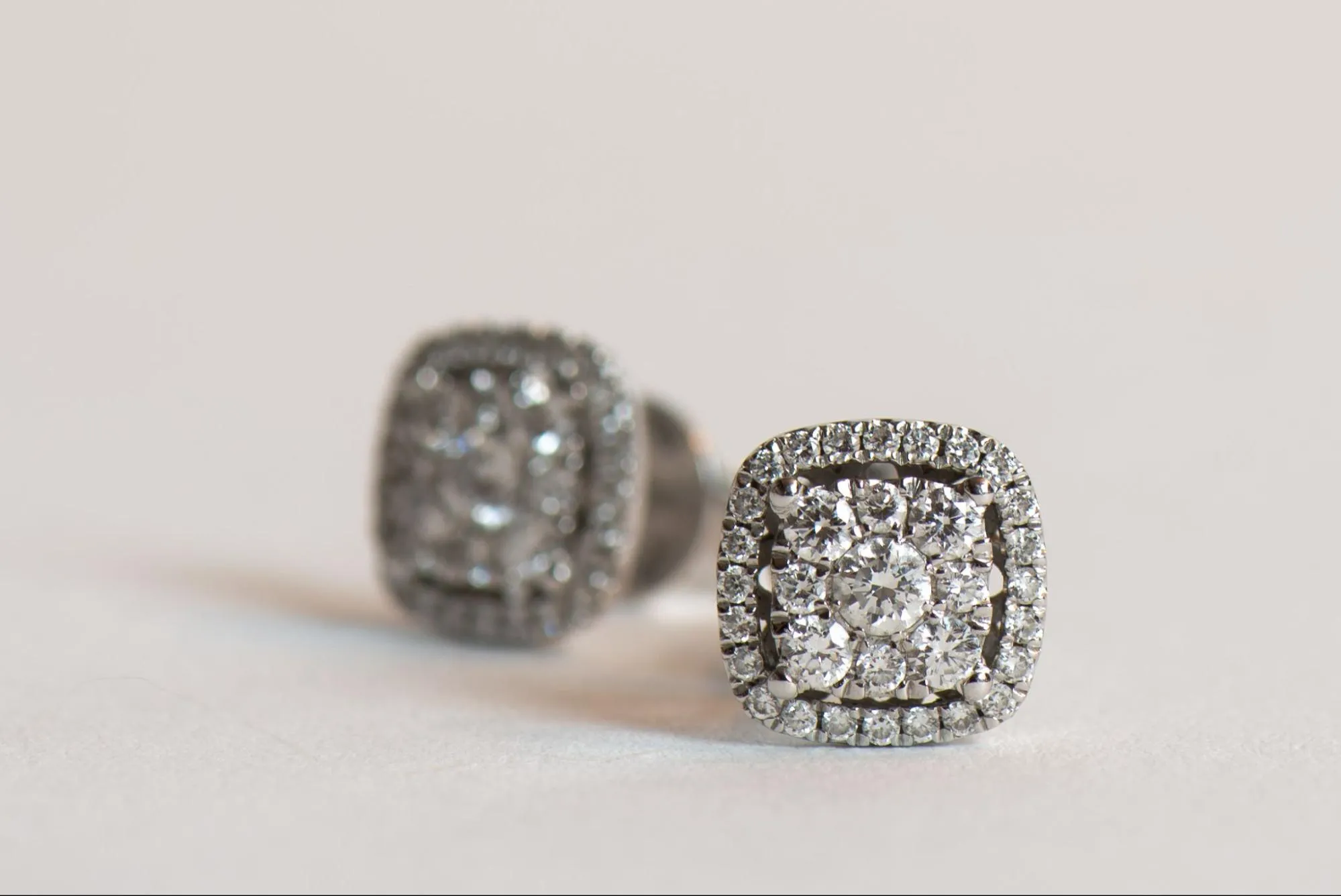 Pair of diamond earrings on white background