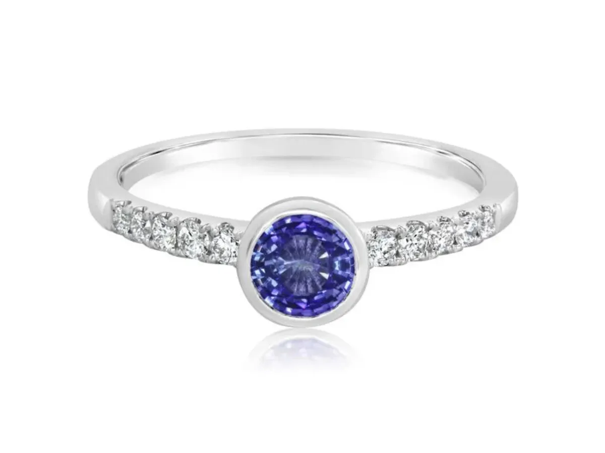 Round blue sapphire bezel ring with diamond band