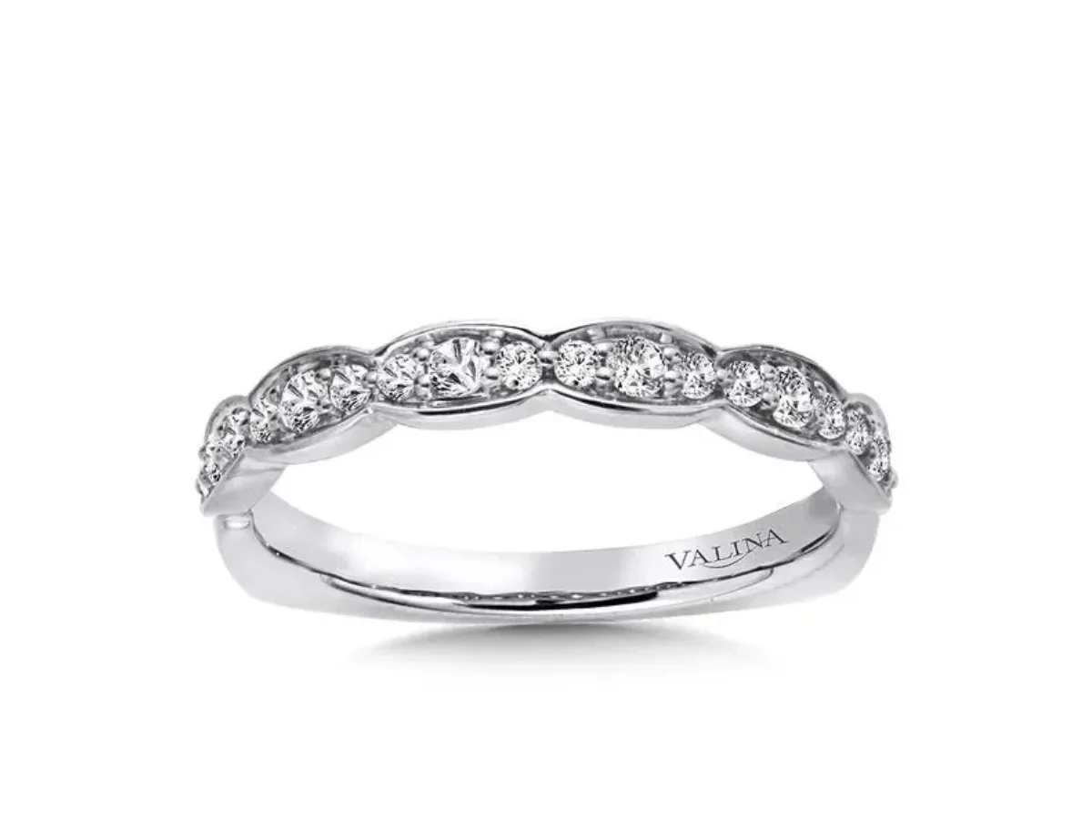 Curved white gold diamond wedding band with pavé accents