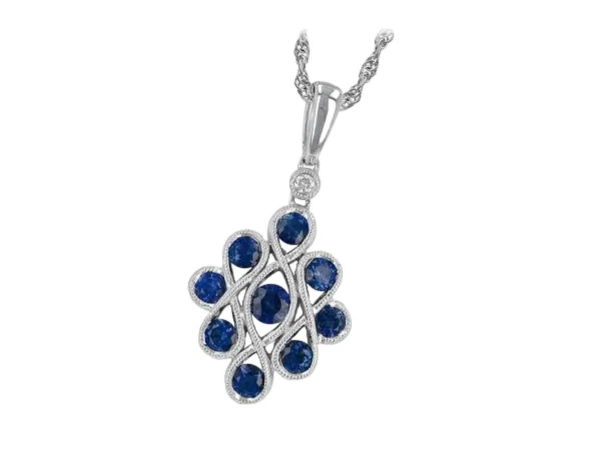 Blue sapphire pendant in white gold diamond setting