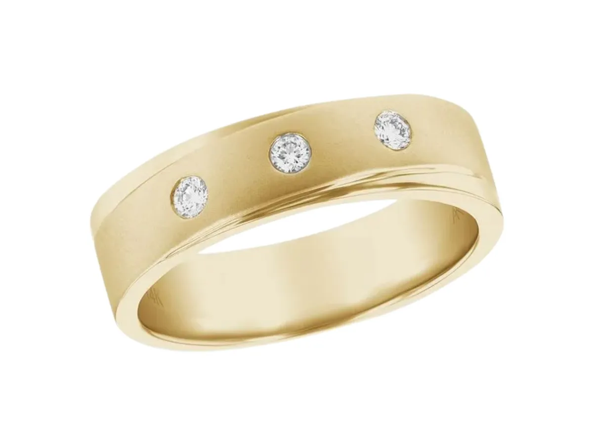 Yellow gold diamond wedding band with bezel accents