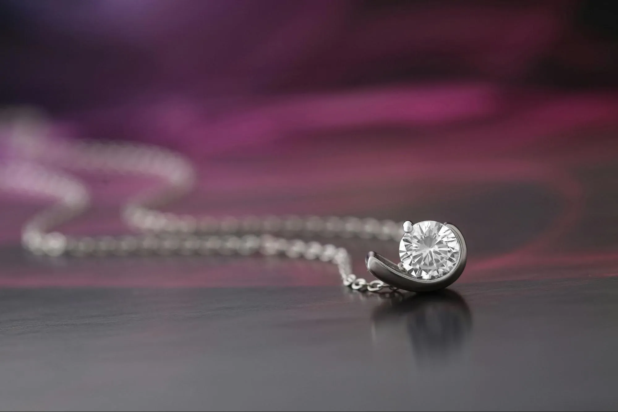 Silver necklace featuring diamond pendant