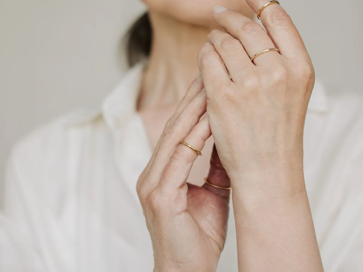 Close-up of gold rings on hands