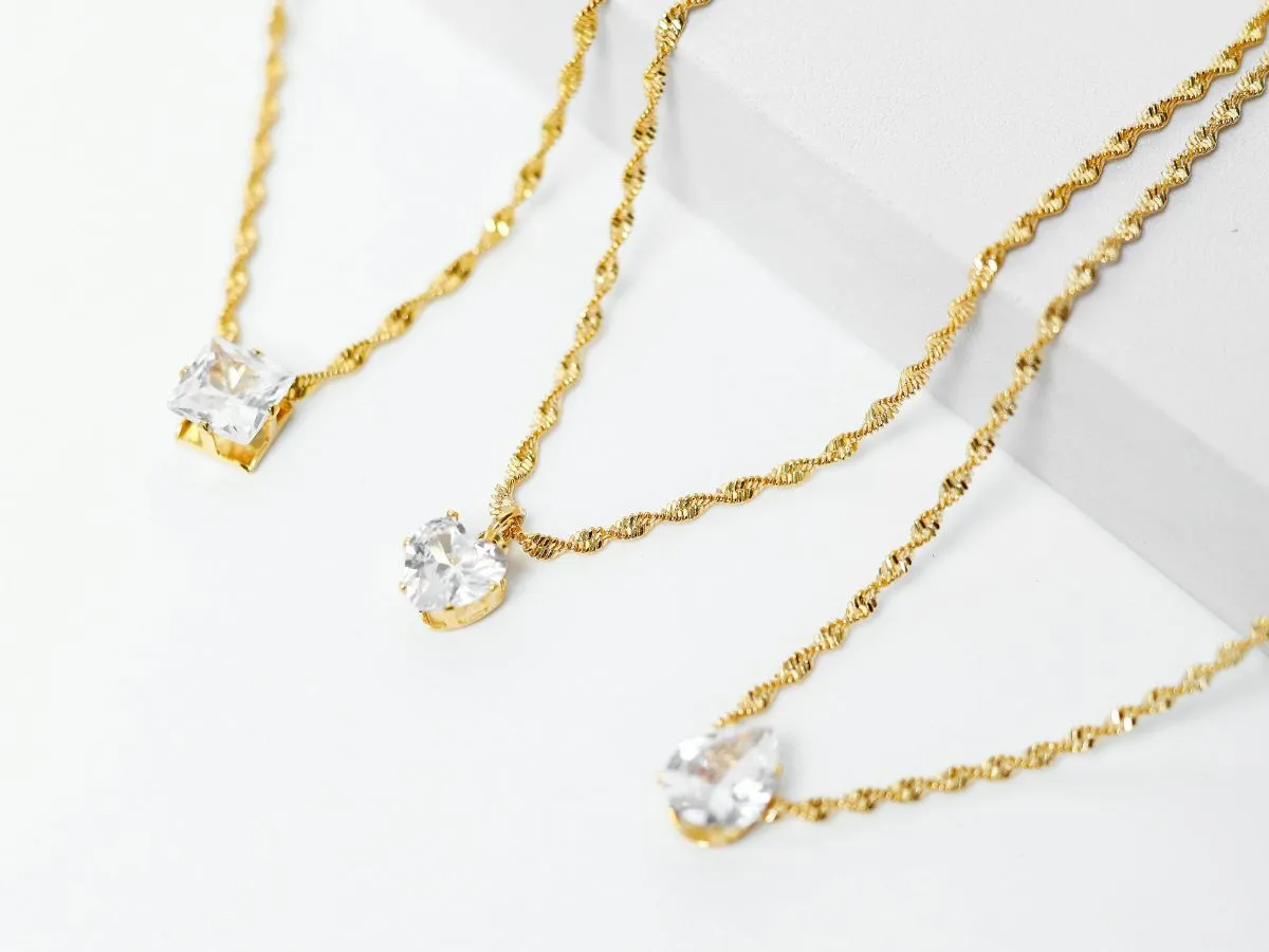 Gold necklaces with crystal pendants