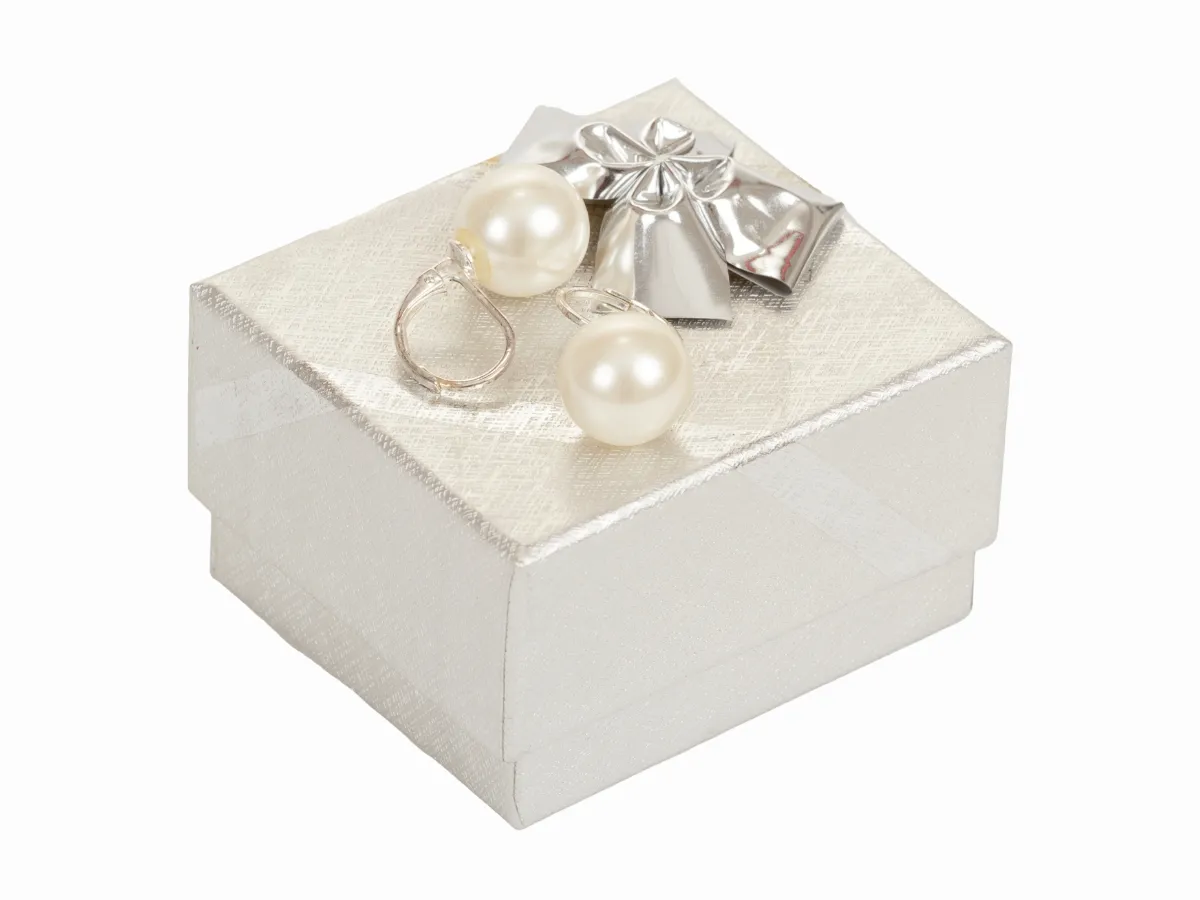 Pearl earrings on gift box.