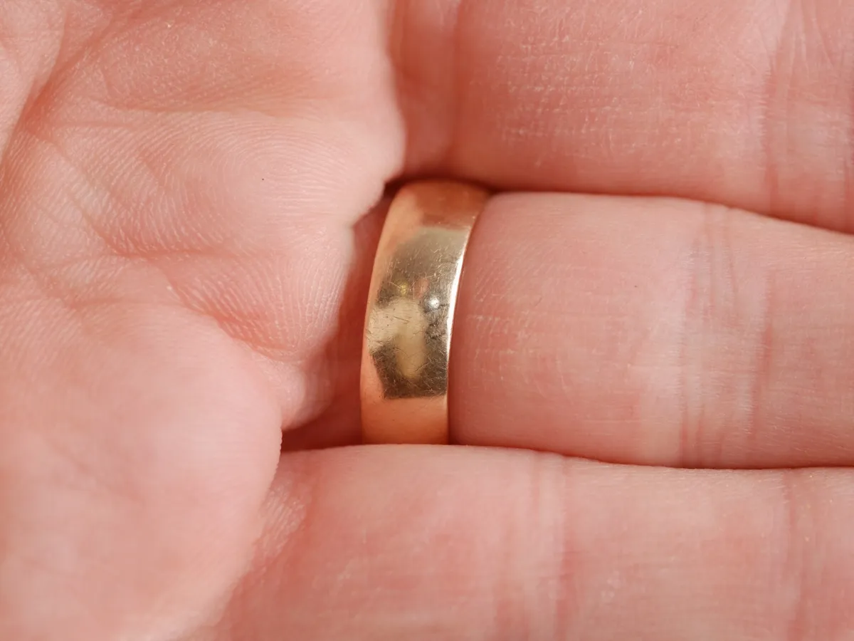 Gold ring held in hand