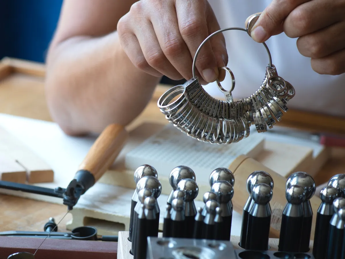 Jeweler examining metal ring gauge