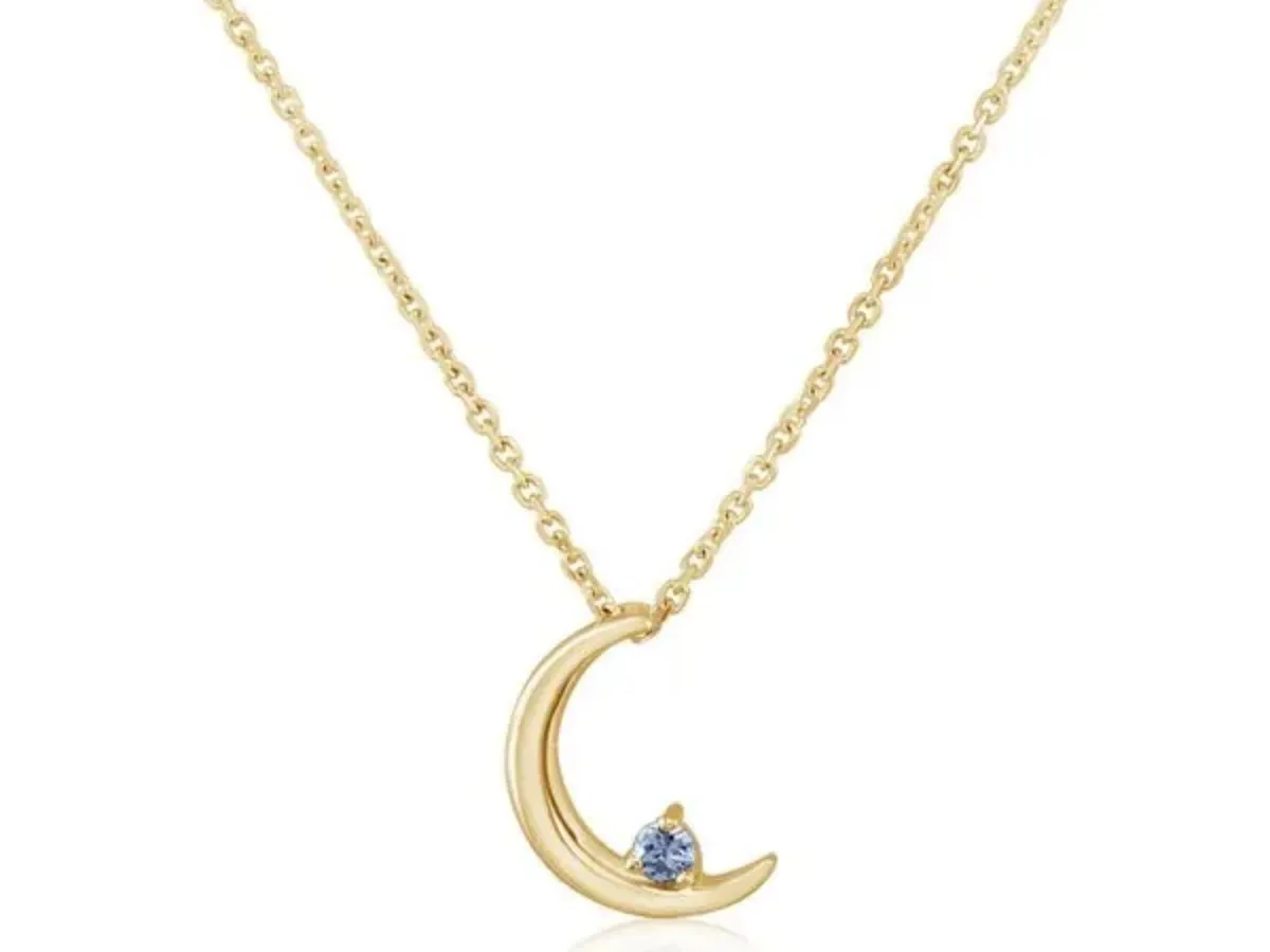 Gold crescent moon pendant with gemstone