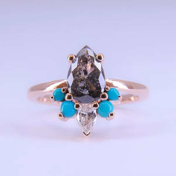 Custom rose gold ring with a pear-shaped salt and pepper diamond and turquoise accents