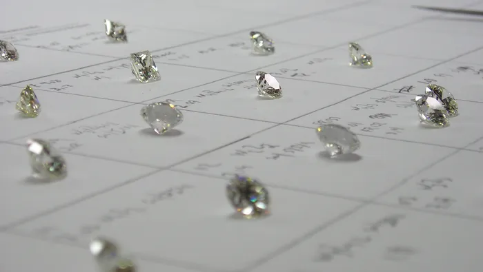 Loose diamonds laid out on a grading sheet for evaluation