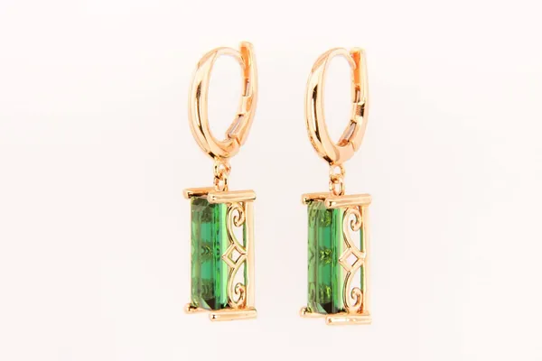 Custom gold drop earrings with emerald-cut green gemstones
