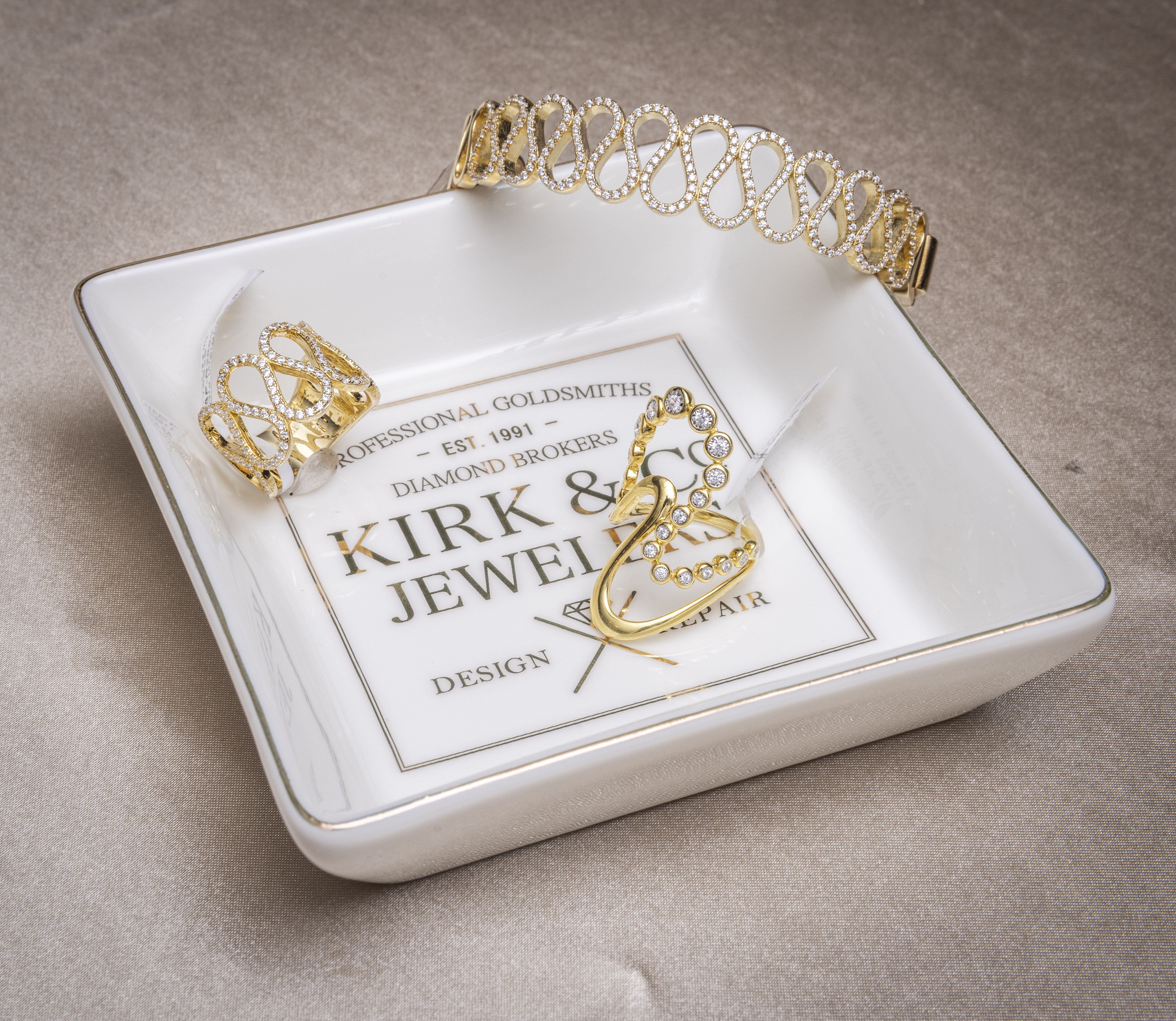 gold jewelry in a Kirk & Co Jewelry tray