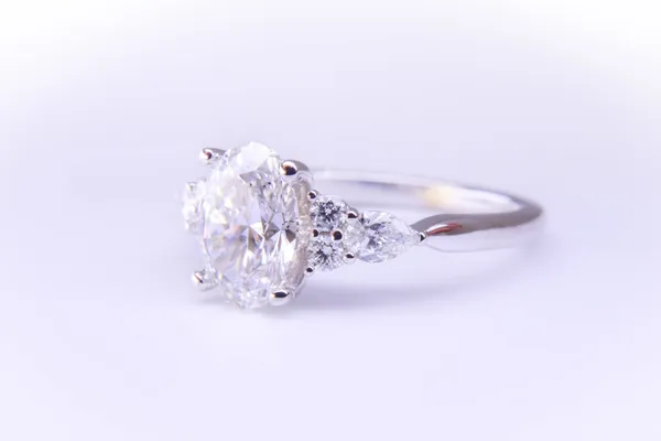 Custom oval diamond engagement ring with diamond side stones