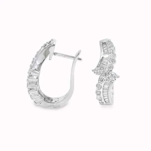 Elegant diamond hoop earrings with baguette and round stones. Explore more Estate Jewelry.